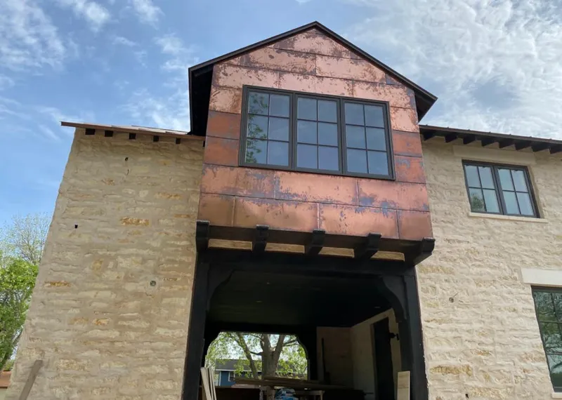 Copper metal panel facade on a stone building for Skylight Installation in Mountainside