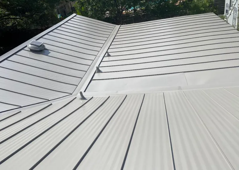 Solar attic fan installed on a metal roof for Roof Ventilation in Mountainside
