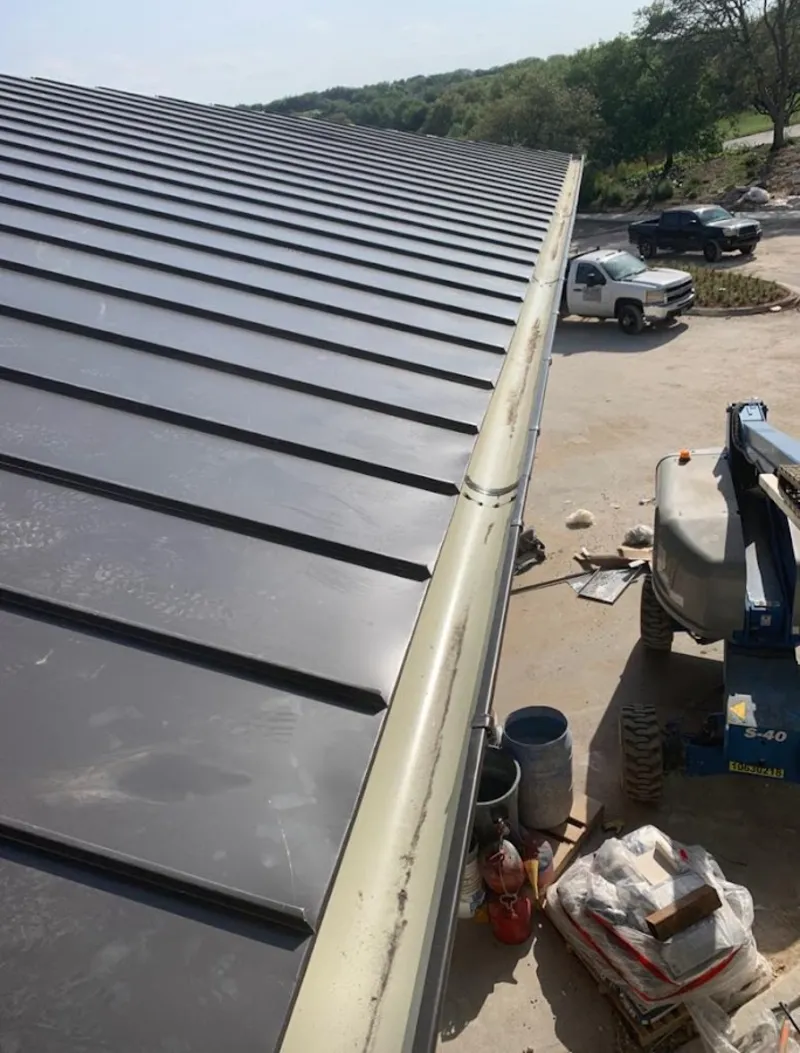 Standing seam panel and gutter detail on a metal roofing jobsite in Mountainside